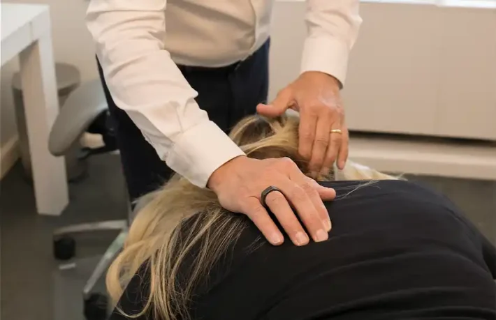 Image of chiropractor applying a high velocity low amplitude adjustment.