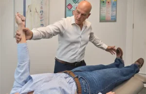 Chiropractor using the manual muscle testing technique
